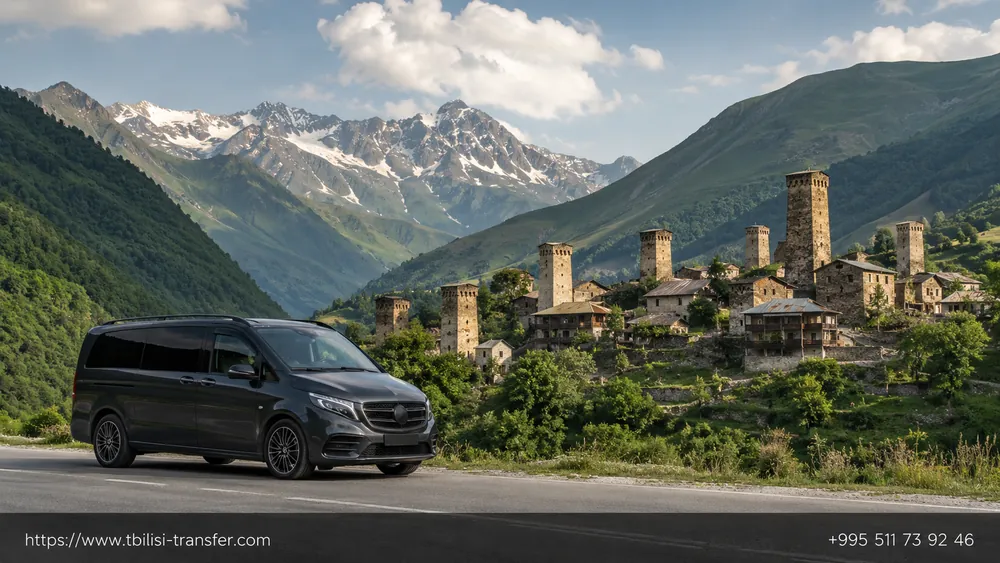 Road into Svaneti — car with Mestia's medieval Svan towers in the background